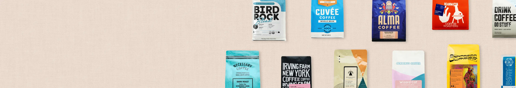 Collection of colorful coffee bags against on a beige background.