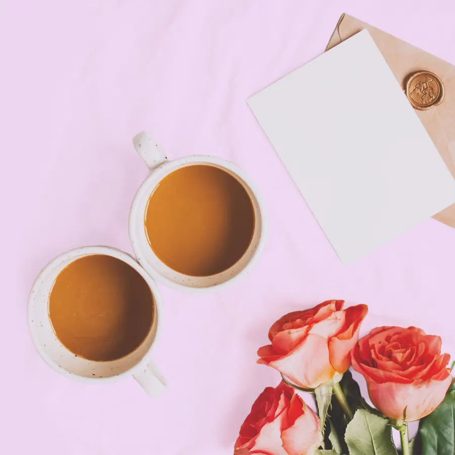 Coffee cup with roses and an envelope