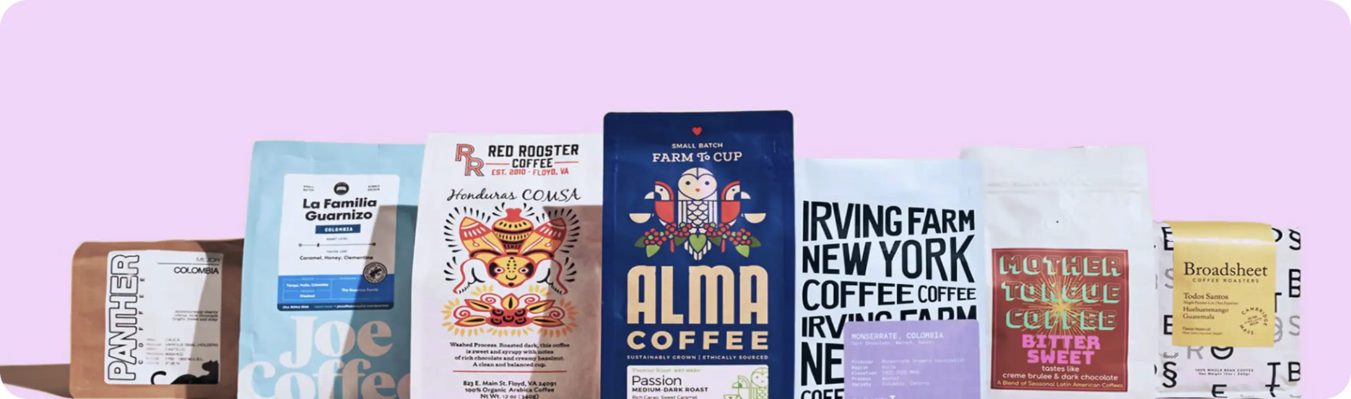 Collection of coffee bags with various designs and branding on a light purple background